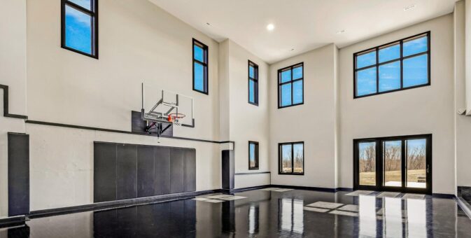 Saddlebrook custom home in Mequon by Kingfogl – basement basketball court view 1