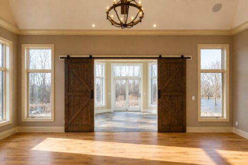 Sanctuary custom home in Menomonee Falls by Kingfogl – hearth room barn doors to sunroom