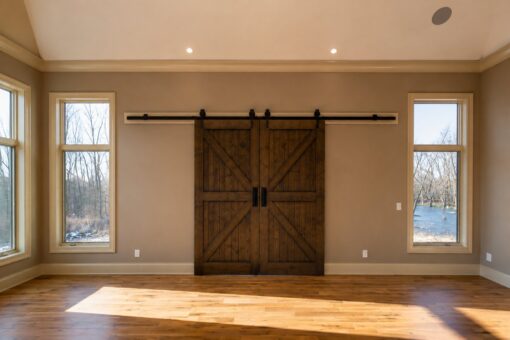 Sanctuary custom home in Menomonee Falls by Kingfogl – hearth room barn doors closed
