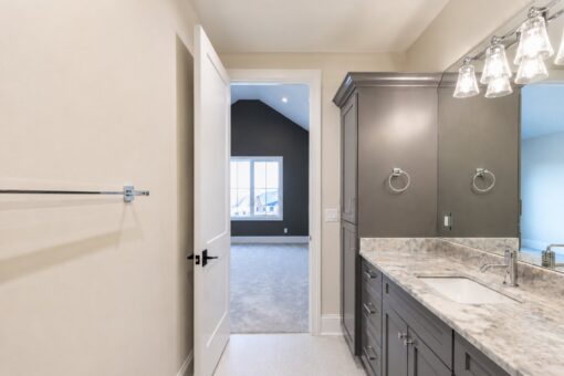Sanctuary custom home in Menomonee Falls by Kingfogl – bathroom vanity and bedroom doorway