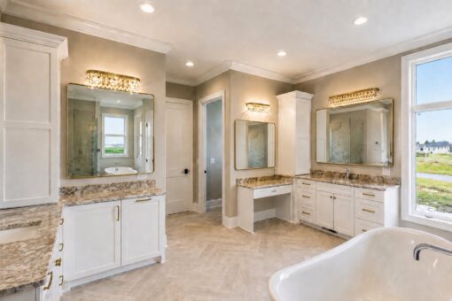 Sanctuary custom home in Menomonee Falls by Kingfogl – primary bathroom vanities and tub view 2