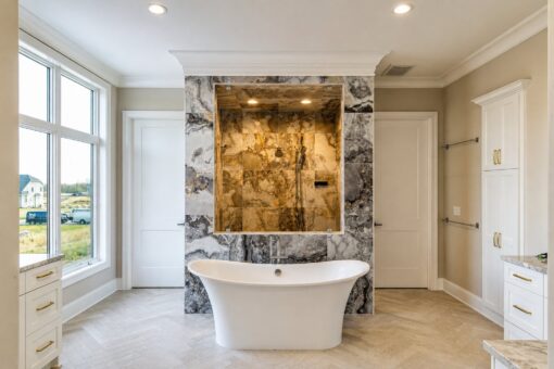 Sanctuary custom home in Menomonee Falls by Kingfogl – primary bathroom tub and shower view 2