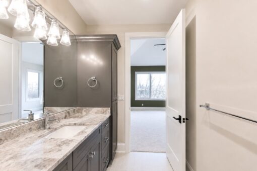 Sanctuary custom home in Menomonee Falls by Kingfogl – 2nd floor bathroom vanity and bedroom doorway