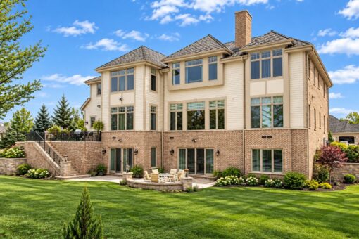 Summerhill custom home in Brookfield by Kingfogl – rear elevation with three stories of windows and patio