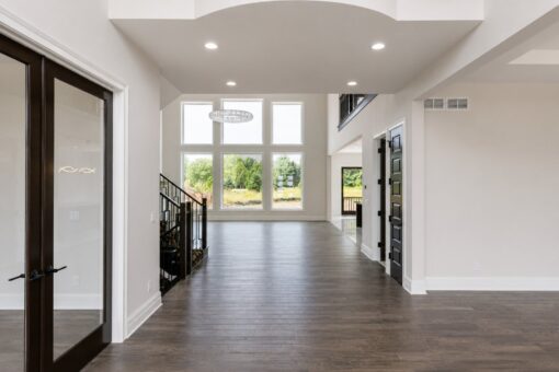 Turnberry custom home in New Berlin by Kingfogl – foyer arched opening to great room