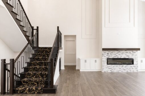 Turnberry custom home in New Berlin by Kingfogl – grand staircase runner and fireplace