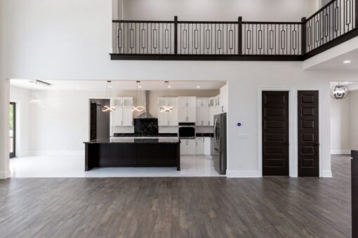 Turnberry custom home in New Berlin by Kingfogl – great room toward kitchen and balcony