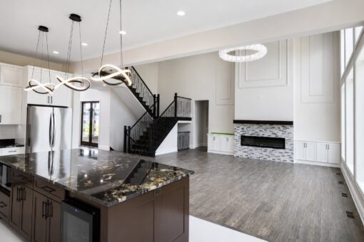 Turnberry custom home in New Berlin by Kingfogl – kitchen island toward great room wide