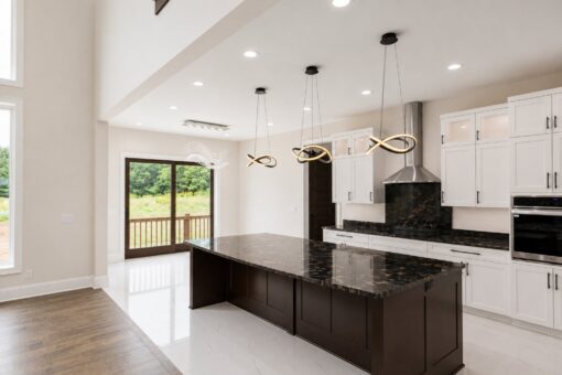 Turnberry custom home in New Berlin by Kingfogl – kitchen island toward patio doors