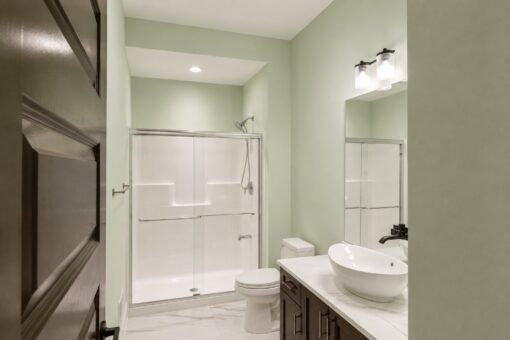 Turnberry custom home in New Berlin by Kingfogl – guest bath shower and vessel sink