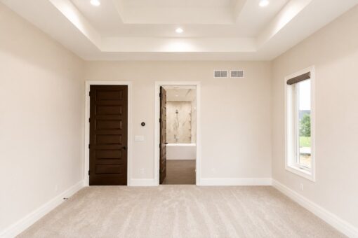 Turnberry custom home in New Berlin by Kingfogl – master bedroom tray ceiling and bath entry
