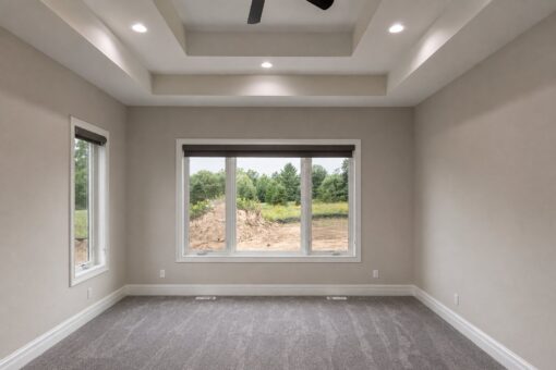 Turnberry custom home in New Berlin by Kingfogl – master bedroom tray ceiling and windows