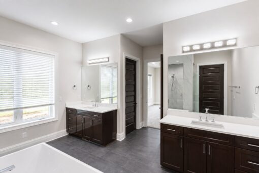 Turnberry custom home in New Berlin by Kingfogl – master bath dual vanities and tub
