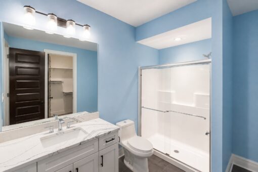 Turnberry custom home in New Berlin by Kingfogl – blue bath vanity shower and closet