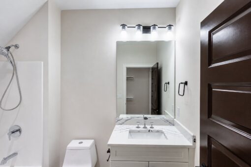 Turnberry custom home in New Berlin by Kingfogl – hall bath vanity and shower