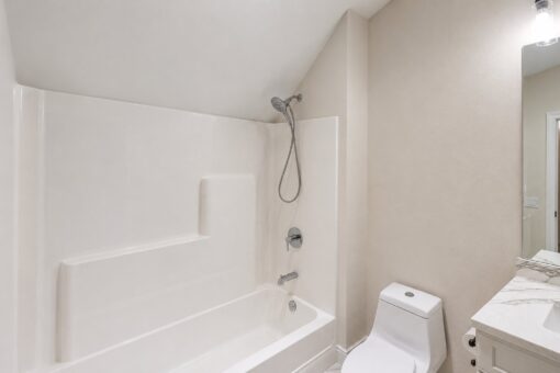 Turnberry custom home in New Berlin by Kingfogl – hall bath tub shower and toilet