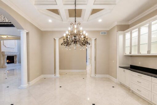 Vizzini custom home in Franklin by Kingfogl – 1st floor - dining room chandelier and built-ins