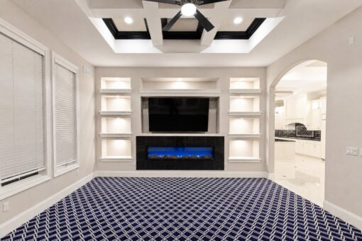 Vizzini custom home in Franklin by Kingfogl – 1st floor - family room fireplace and built-ins - night