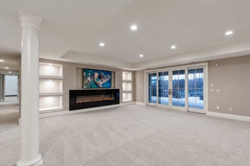 Vizzini custom home in Franklin by Kingfogl – basement - media room fireplace and patio