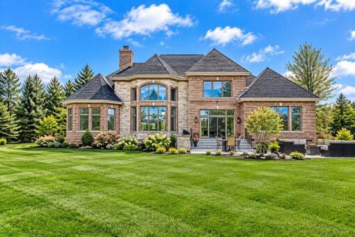 Wildwood custom home in Mequon by Kingfogl – rear elevation with brick exterior and landscaping