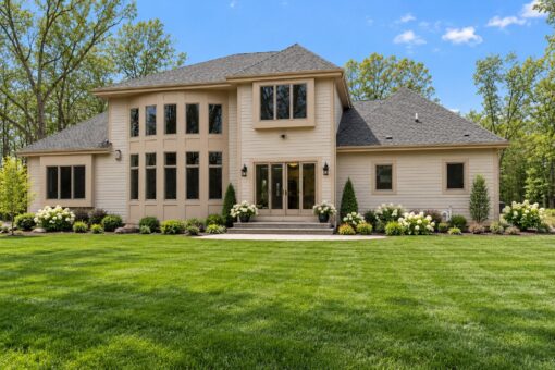 Woodview custom home in Brookfield by Kingfogl – rear elevation with tall windows and patio