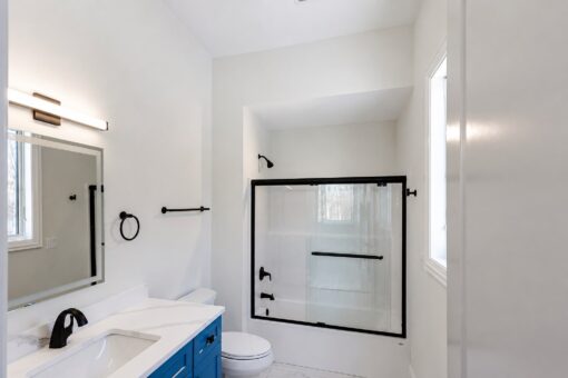 Apex bathroom with blue vanity and tub-shower