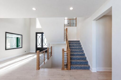 Apex foyer staircase with carpet runner and cable railing