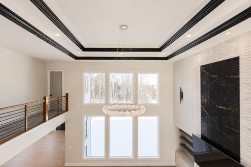 Apex great room fireplace and ring chandelier from the balcony