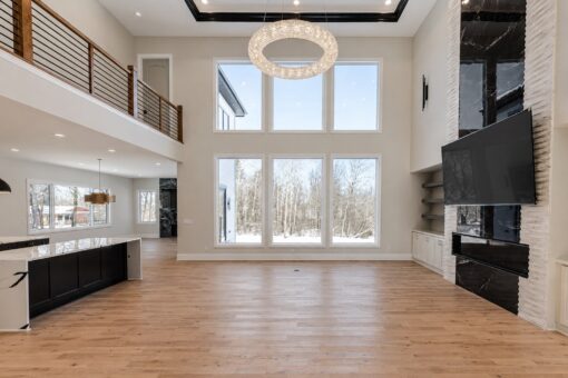 Apex great room with marble fireplace, window wall and balcony