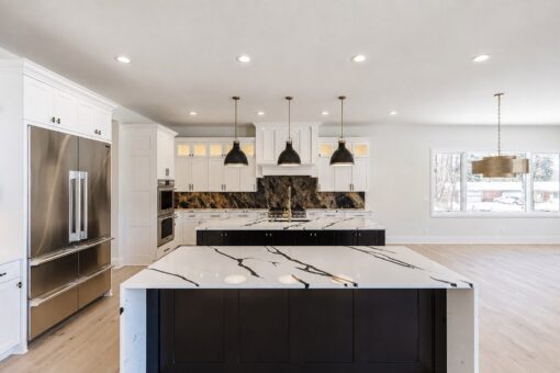 Apex kitchen island with waterfall quartz and built-in refrigerator