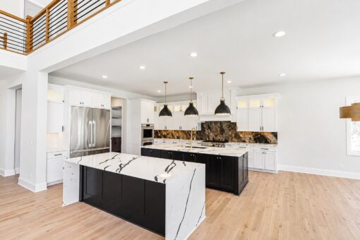 Apex kitchen with two islands and black pendant lights