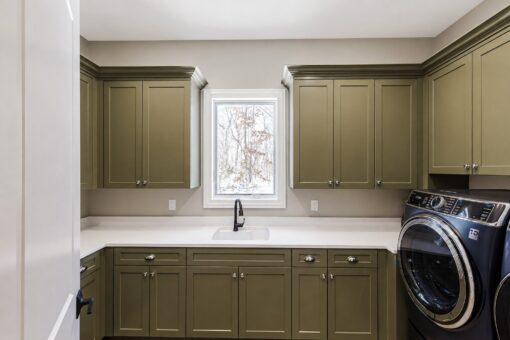 Apex laundry room with green cabinetry