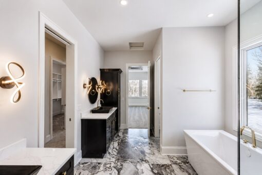 Apex primary bath with sculptural sconces and freestanding tub