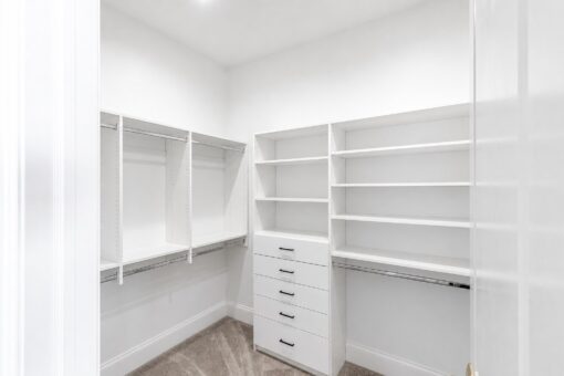 Apex primary closet with built-in shelving and drawers