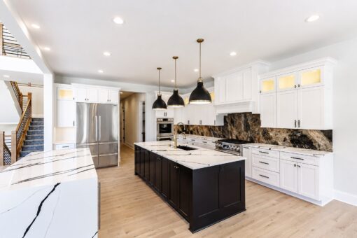 Apex white kitchen with black island, waterfall quartz and marble backsplash