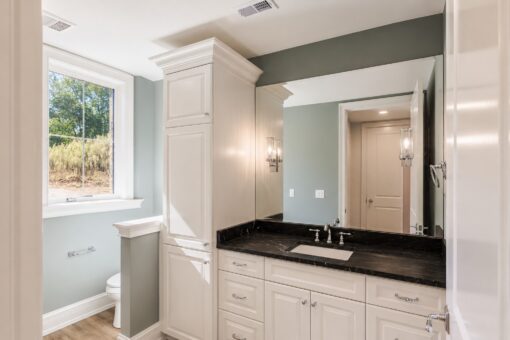 Ridge bathroom with dark granite vanity and window
