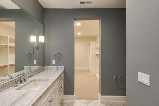 Ridge bathroom with gray walls and walk-in closet