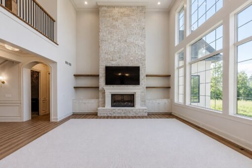 Ridge great room with floor-to-ceiling windows and stone fireplace
