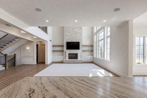 Ridge great room with stone fireplace viewed from the kitchen island