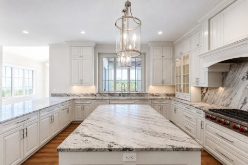 Ridge kitchen with marble island, lantern pendant and range hood