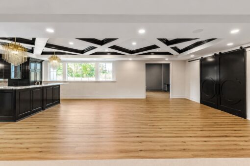 Ridge lower-level bar with black cabinetry and barn doors