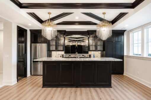 Ridge lower-level kitchen with black island and crystal chandeliers
