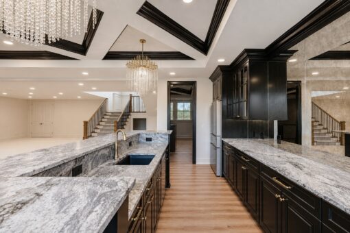 Ridge lower-level kitchen with granite counters and black cabinetry