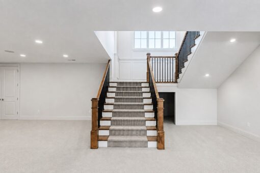 Ridge lower-level staircase with iron balusters