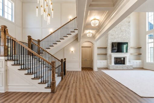 Ridge open staircase with modern chandelier and great room view