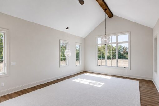 Ridge primary bedroom with vaulted beamed ceiling