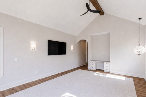 Ridge primary bedroom with vaulted ceiling and built-in desk