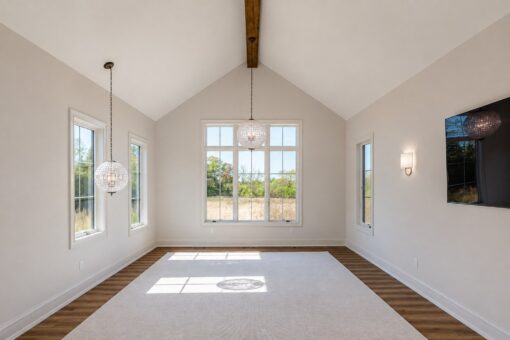 Ridge primary bedroom with vaulted ceiling and crystal chandeliers