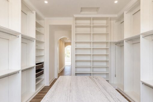 Ridge primary closet with marble island and built-in shelving