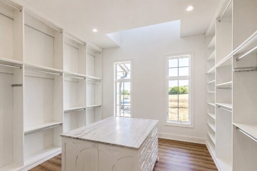 Ridge primary closet with skylight and window